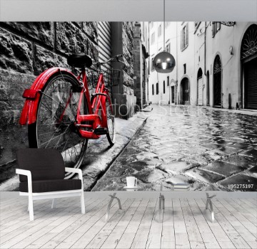 Bild på Retro vintage red bike on cobblestone street in the old town Color in black and white
